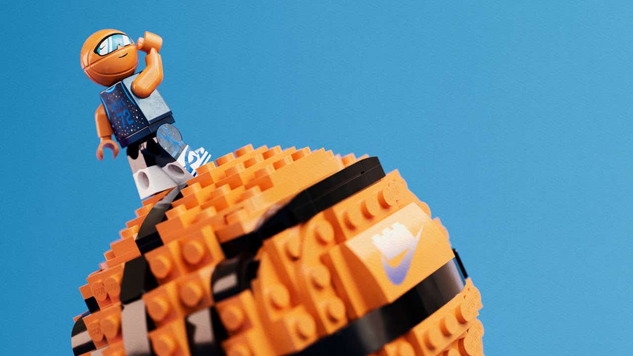 LEGO basketball minifigure standing atop an orange brick-built basketball featuring a Nike logo, set against a bright blue background from the LEGO x Nike collaboration 2025