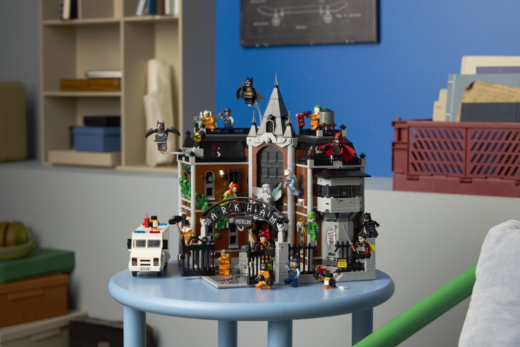 LEGO Batman Arkham Asylum set showcased on a blue round table with surrounding characters