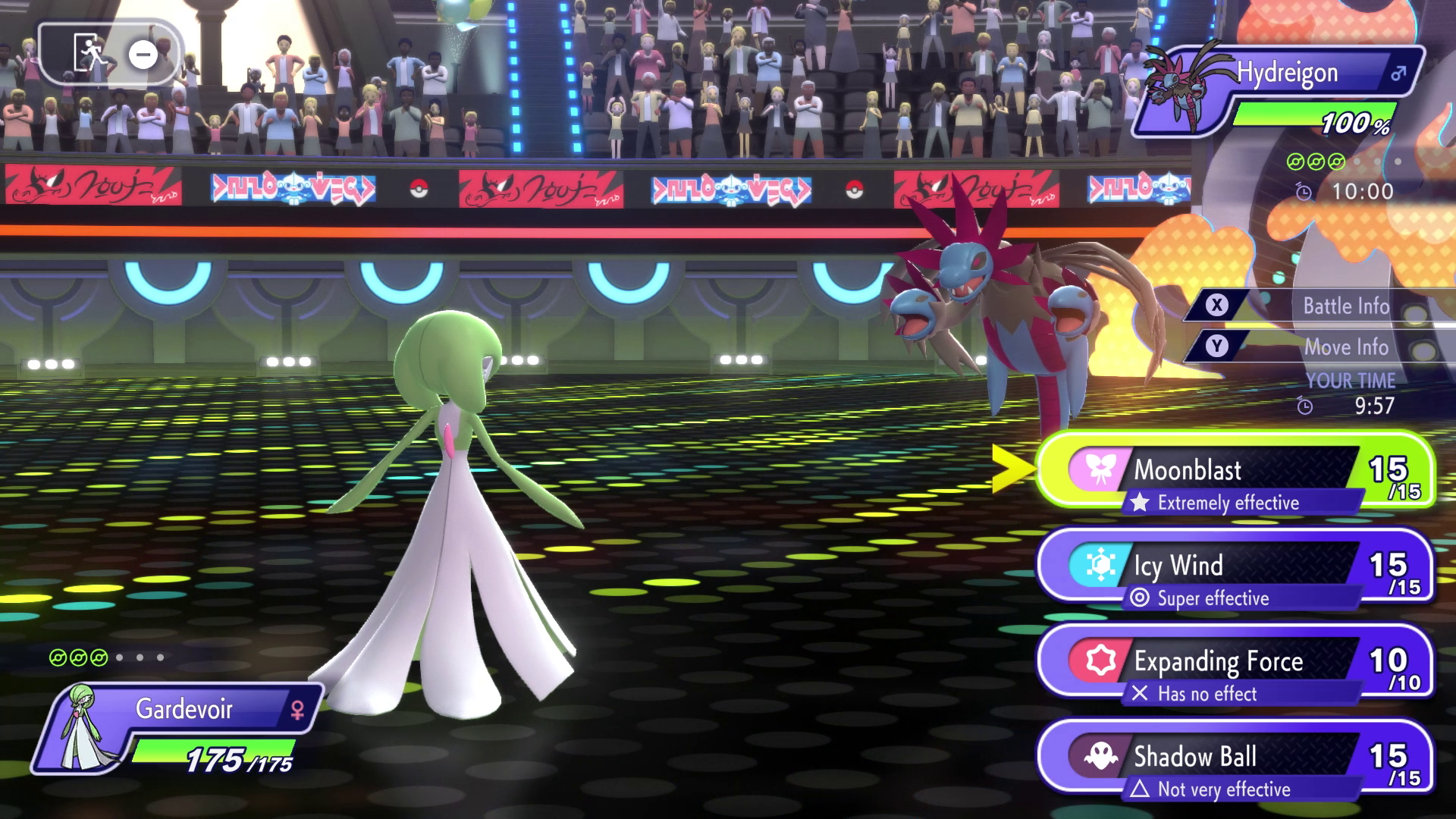 Gardevoir prepares to use Moonblast against Hydreigon in a competitive battle arena in Pokémon Champions, showcasing move effectiveness and UI from the game’s turn-based system.