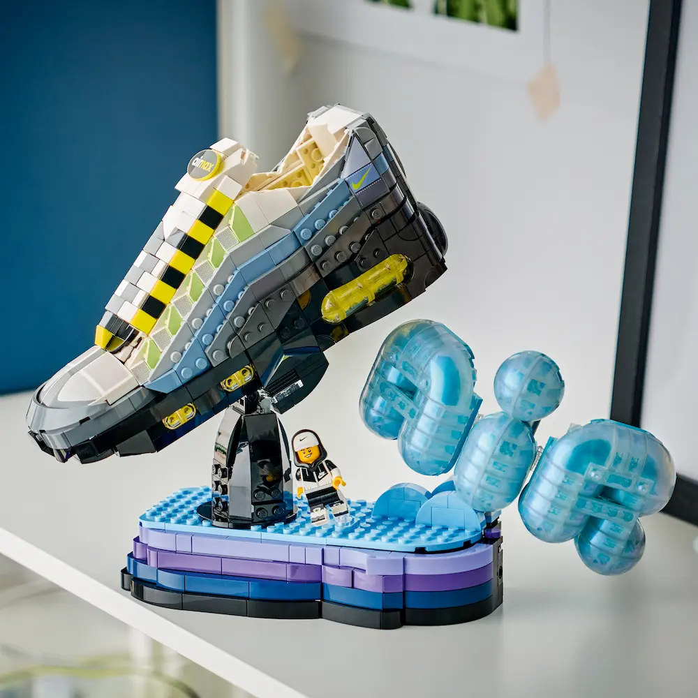 Nike Air Max 95 x LEGO - Fandom Frontiers LEGO Nike Air Max 95 sneaker model on display stand with blue Air bubble elements and minifigure
